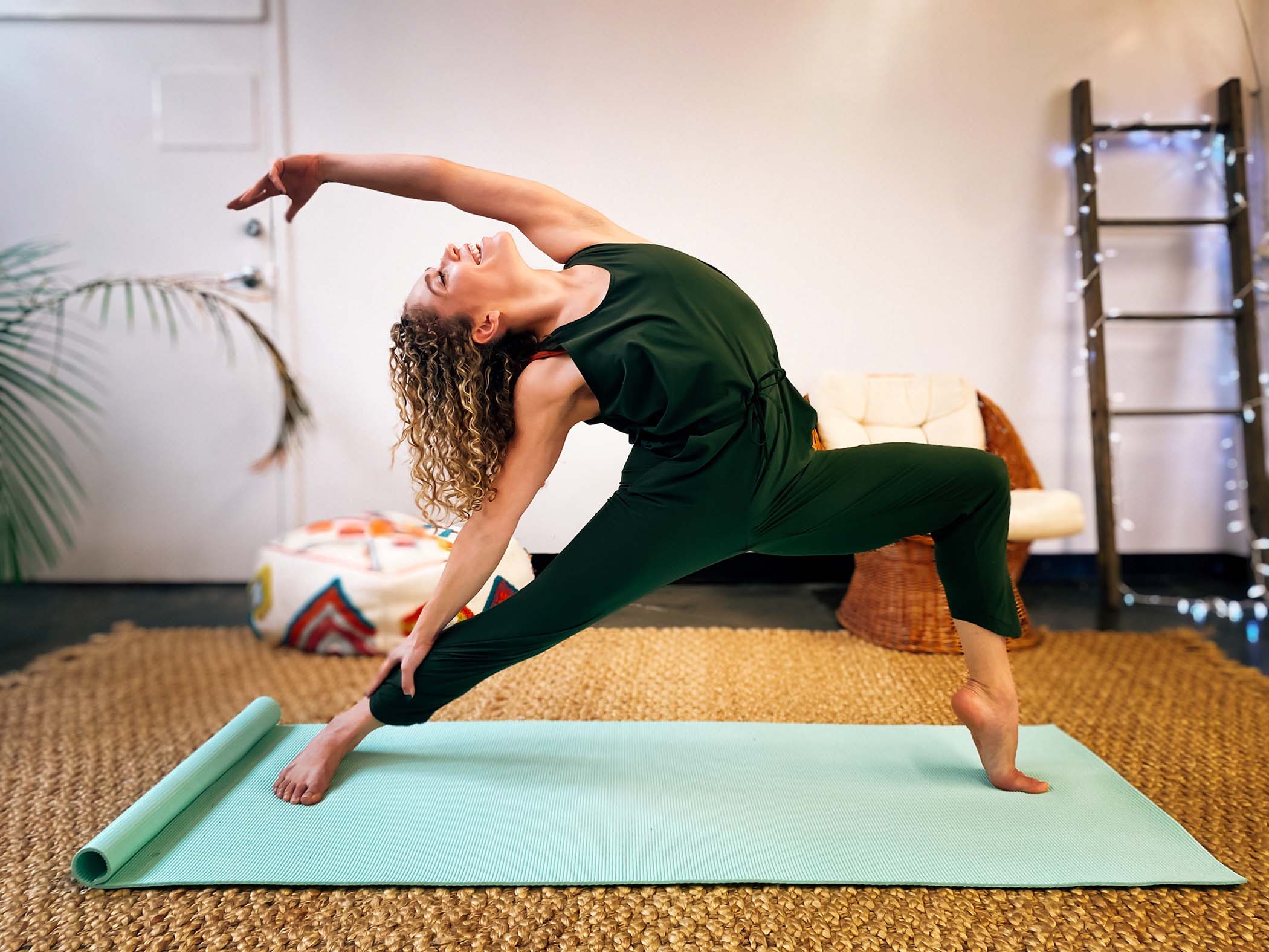 Woman practising a supported yoga pose at home