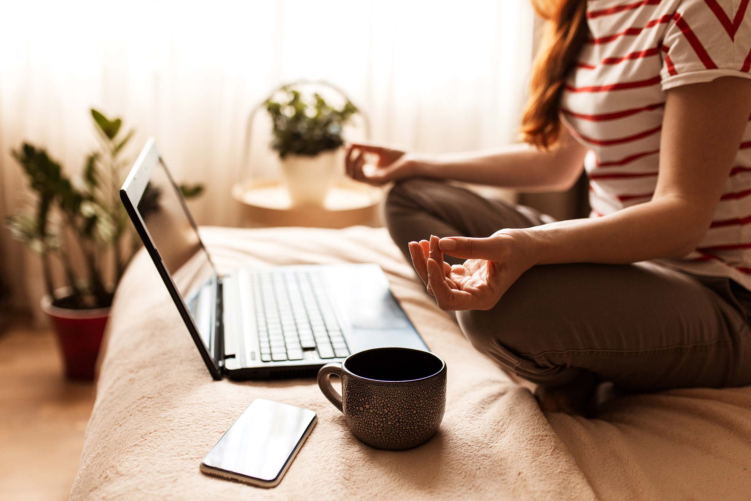 Woman taking a quiet break beside her laptop at home